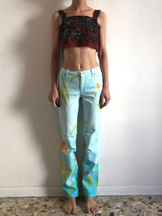 1990s Roberto Cavalli Jeans with a cool sky blue background and spring flower print.  90's club kid fabulousness! These jeans are mixed stretch cotton denim.  Jeans are cut with a straight leg that is just slightly tapered towards the ankle.  Five pocket details. Metal zipper up the front.  Roberto Cavalli metal button at waist and logo rivets.  Label Roberto Cavalli, Made in Italy. Size 30. 95% cotton, 5% elastic. Machine wash warm and hang dry.  Very good vintage condition with no fabric or sewing flaws. Fabric is soft and faded,  Measurements - jeans have stretch Waist 70cm/ 28inches Hips 98cm/ 38.5inches Rise 23cm/ 9inches Waist to hem 99cm/ 39inches Models measurements Shoulders 42cm/ 16.5inches Chest 84cm/ 33inches Waist 66cm/ 26inches Hips 92cm/ 36inches Height 175cm/ 5'9'' Cavalli Jeans, Sky Blue Background, Cotton Gauze Dress, Cotton Slip, Boho Summer Dresses, Gauze Dress, Printed Jeans, Bell Bottom Pants, Black Denim Jeans