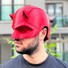 **3D Printed Daredevil Cowl Helmet: Unleash Your Inner Hero** Step into the world of superheroes with our meticulously crafted Daredevil Cowl Helmet, a stunning replica designed for fans and cosplayers alike. This one-of-a-kind piece is 3D printed using high-quality, durable plastic that ensures both longevity and comfort.  Our Daredevil Cowl Helmet is designed to fit adult heads comfortably, allowing for easy wear during conventions, Halloween, or just for fun! Whether you're looking to impress at your next cosplay event, create an unforgettable gift for a Daredevil fan, or simply show off your love for this iconic superhero, this helmet is sure to turn heads. The interior is thoughtfully lined for a snug fit, ensuring that you can enjoy wearing it for hours without discomfort. ● Material Costume Mask, Just For Fun, Easy Wear, Costume Accessories, Sell On Etsy, Mask, Art Collection, Bathing Beauties, Purses And Bags