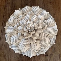 a paper flower made out of old book pages