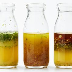 three jars filled with different colored liquids