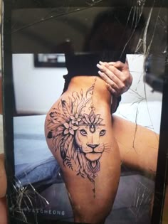 a person holding up a cell phone with a tattoo on the side of their leg