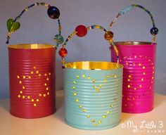 three tin cans decorated with beads and string