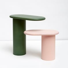 two different colored stools sitting next to each other