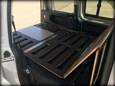 the back end of a truck with its cargo tray open