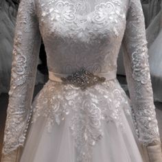 a white wedding dress on display in a store