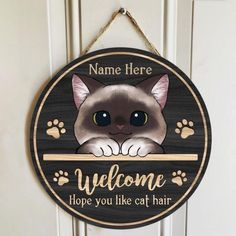 a wooden sign with a cat on it that says welcome to hope you like cat hair