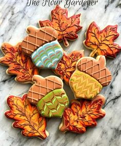 cookies decorated with autumn leaves on a marble surface