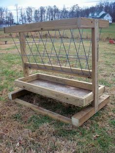 a wooden bench sitting in the middle of a field