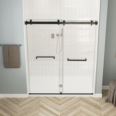 a white shower door in a bathroom next to a chair