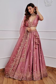 Aurora pink lehenga with gold dori, aari and sequin embroidery. Comes with half sleeves blouse and organza dupatta. Component: 3 Pattern: Embroidery Type Of Work: Sequin, Dori and Aari Neckline: Leaf Sleeve Type: Half Fabric: Chanderi and Organza; Lining: Satin Color: Pink Other Details:  Dupatta with scalloped embroidery border Tassels on the sides Note: Only selling the product mentioned in the description from the video. Occasion: Wedding - Aza Fashions Lehenga For Party Indian Weddings, Lehenga Look For Reception, Reception Lehenga Ideas, Pink Lehanga Ideas, Night Wedding Lehenga, Wedding Lengha Designs Latest, Bridal Simple Lehenga, Bollywood Lehenga Outfit Ideas, Heavy Lehenga Indian Weddings