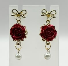 Here, we have an assortment of gorgeous earrings that make an ideal gift for Valentine's day. This collection as a whole has an elegant appearance with a Baroque-inspired aesthetic. No two pairs, however, are exactly alike, so there is a suitable style option for anyone. A wide variety of decorations such as pearls, hearts, roses and even bows make each individual pair unique. These earrings are the perfect Valentine's day gift for one's wife or girlfriend.  The bows are made of silk fabric while everything else is made from glass, brass and alloy. In addition, the beads (both round and teardrop-shaped) are imitation pearl beads which are made from glass. Elegant Rose Red Earrings For Valentine's Day, Elegant Rose Red Earrings Gift, Rose Earrings For Valentine's Day, Rose Red Valentine's Day Earrings With Rose Design, Elegant Rose Red Flower-shaped Earrings, Formal Accessories, Unique Valentines Gifts, Valentines Gifts For Him, Fancy Jewelry