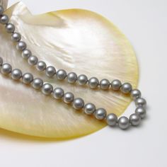 8mm Grey Color Round Pearl Necklace Genuine Freshwater Cultured Pearl Necklace for Women and Men Real Pearls Gift for her Gift for him PRODUCT INFORMATION: * Pearl Type: Genuine freshwater pearls with natural luster. * Pearl Color: See photo. * Pearl Shape and Size: Round freshwater pearls, 8-8.5mm  * Pearl Luster: Very Slightly blemished. * Necklace Length: available in 16", 17" and 18".  If you require other length please contact us. * Clasp: Base metal with Rhodium plated. PROCESSING TIME & S Luxury Gray Pearl Necklace As Gift, Gray And White Pearl Necklace, Silver Pearl Necklace With Black Round Beads, Elegant Gray Round Pearl Necklace, Formal Gray Pearl Necklace, Gray Pearl Necklace, Black Pearl Necklace, Pearl Gifts, Cultured Pearl Necklace