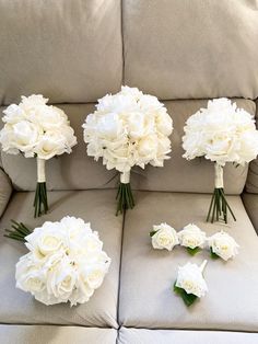 the bridal bouquets are arranged on the couch