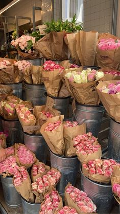 several buckets filled with pink and white flowers