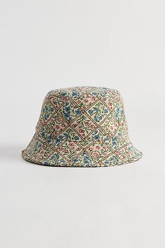 a colorful hat with an intricate pattern on the front and side, against a white background