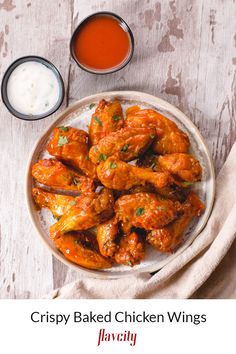 crispy baked chicken wings on a plate with dipping sauce