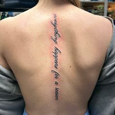 the back of a woman's neck with writing on it