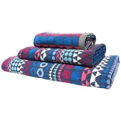 two blankets folded on top of each other with different patterns and colors in the middle