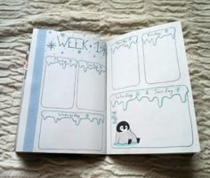 an open planner book with stickers and writing on the pages is sitting on a bed