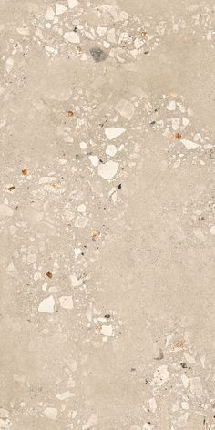 an old, dirty concrete surface with small rocks and gravel on it's sides