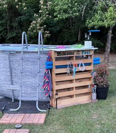 an above ground swimming pool with wooden pallets and accessories in the yard next to it