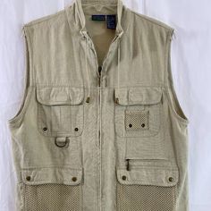 Country Club By Koret Beige Sleeveless Utility Vest Nwot Women's Size Medium Khaki Beige Utility Vest With Lots Of Zip, Velcro & Snap Closure Pockets. Drawstrings For Added Comfort And Full Zip Front. 55% Linen, 45% Rayon. Decor Is 100% Cotton. Machine Wash Cold Water Gentle Cycle And Tumble Dry Low Heat. Top Shoulder Seam To Bottom Hem 24" Bust 44" Waist 44" Hips 44" Safari Shirt Women, Tan Utility Vest, Sleeveless Outerwear With Pockets For Spring, Sleeveless Spring Outerwear With Pockets, Summer Khaki Vest With Pockets, Utility Sleeveless Tops With Pockets, Sleeveless Utility Top With Pockets, Sleeveless Outerwear For Spring Outdoor Activities, Sleeveless Spring Outerwear For Outdoor