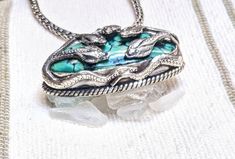 This Green Turquoise Snake Pendant is a stunning piece of jewelry that features mystical attributes of green coral. The vibrant color of the green turquoise combined with the unique snake design makes it a must-have accessory for any occasion. Add a touch of elegance and enchantment to your outfit with this beautiful pendant. 92.5 Sterling Silver, 1" L Textile Tapestry, Snake Pendant, Snake Design, Gongs, Mala Beads, Pendant Rings, Green Turquoise, Pendant Jewelry, Ring Earrings