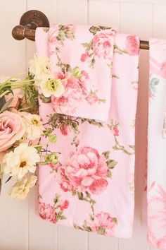 towels hanging on a towel rack with flowers