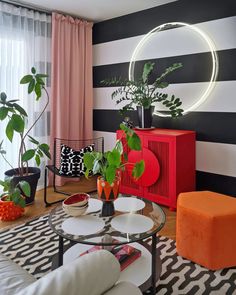 a living room filled with furniture and colorful walls