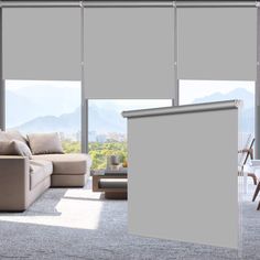 a living room filled with furniture and windows covered in roller shade shades on the sliding glass doors