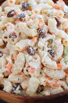 a bowl filled with macaroni salad and raisins on top of it