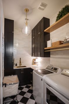 a black and white checkered floor in a laundry room with washer and dryer