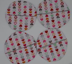 four circles with hearts on them sitting on a table