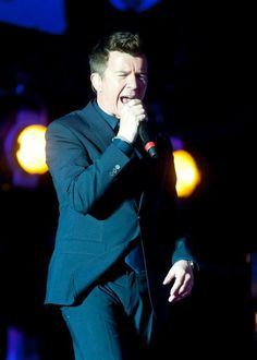 a man in a suit singing into a microphone