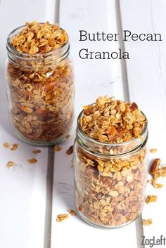 two jars filled with granola sitting on top of a table