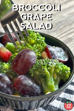 broccoli and grapes are in a bowl with a fork