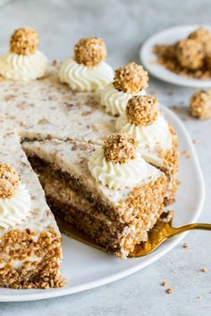 a white plate topped with a cake covered in frosting