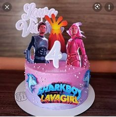 a birthday cake with the name sharkboy lavagirl on it and two people standing behind it