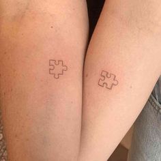 two people with matching tattoos on their legs, one has a puzzle piece tattooed on the other