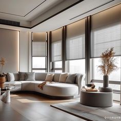 a living room filled with lots of furniture next to tall window covered in blind shades