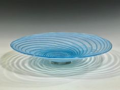 a blue glass plate sitting on top of a table