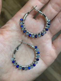 Handcrafted wire wrapped 30mm silver hoop earrings made with 3mm faceted Lapis Lazuli and Blue Topaz gemstones. The hoops are silver plated stainless steal and hypoallergenic. The wire is 26 gauge silver plated copper wire. They are very LIGHTWEIGHT Everything created at Earthly Elegance Designs is handcrafted by Chelsea with love, positive energy, and precise attention to detail. Hi! I'm Chelsea! I have a passion for gemstones and crystals and have been collecting them for over a decade. When I Wrapped Hoop Earrings, Gemstones And Crystals, Lapis Blue, Stainless Steal, Topaz Gemstone, Jewelry Earrings Hoops, Silver Hoops, Silver Hoop Earrings, Making Jewelry