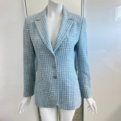 Beautiful Chanel Boutique Women's Jacket/Blazer In A Complex Light Blue Melange Tweed Boucle. There Are White, Black And Soft Pink Threads Infused Throughout. 1998 By Karl Lagerfeld. Made In France. Notched Lapels, Three Button Front Closure With Shoulder Pads And Long Sleeves. The Light Blue Lining Has The Cc Interlocking Logo Repeated Pattern Throughout. Buttons Also Have The Interlocking Cc Iconic Logos. There Is The Iconic Silver Chain Sewn Across The Bottom Hem. Chest Welt Pocket And Two Si Repeated Pattern, Chanel Boutique, Chanel Jacket, Blue Tweed, Tweed Suits, Jacket Blazer, Karl Lagerfeld, Welt Pocket, Shoulder Pads