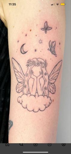 a woman's arm with an angel tattoo on it and butterflies flying around her