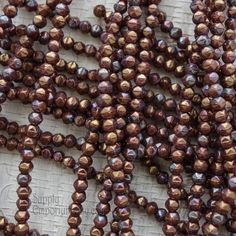 some brown beads are laying on a table