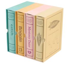 three books are stacked on top of each other in different colors and shapes, one is pink, the other is blue