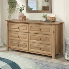 a wooden dresser sitting next to a window