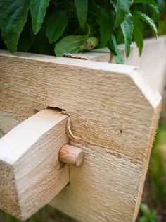 a close up of a piece of wood attached to a planter