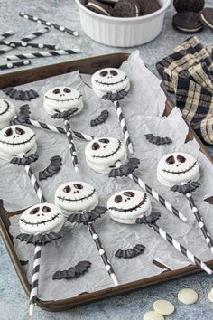 there are many cupcakes decorated like jack skewers on the tray with candy sticks