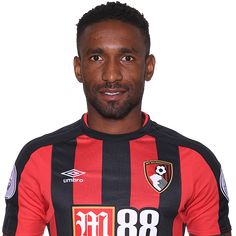 a man wearing a black and red striped soccer jersey with the number 80 on it